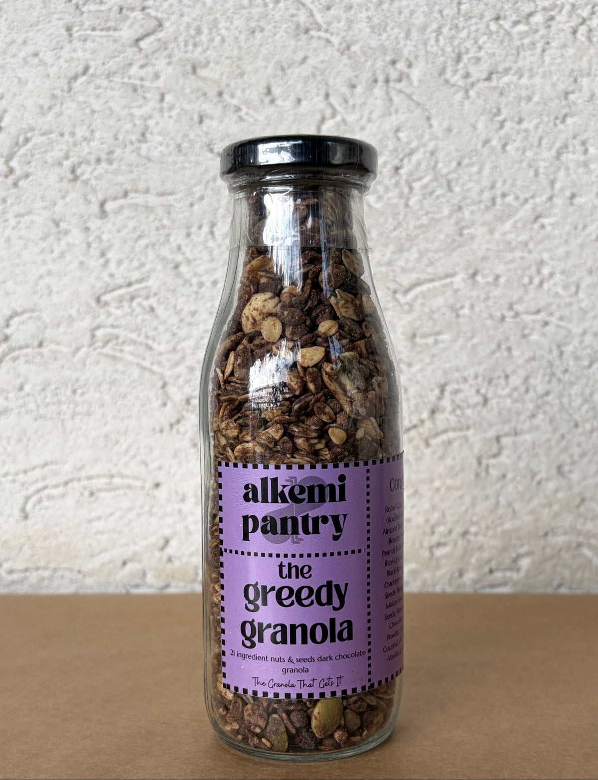 Alkemi Pantry Greedy Granola with 21 ingredients including dark chocolate, nuts and seeds for plant based breakfast, with no artificial flavoring or preservatives and double baked for perfect crunch