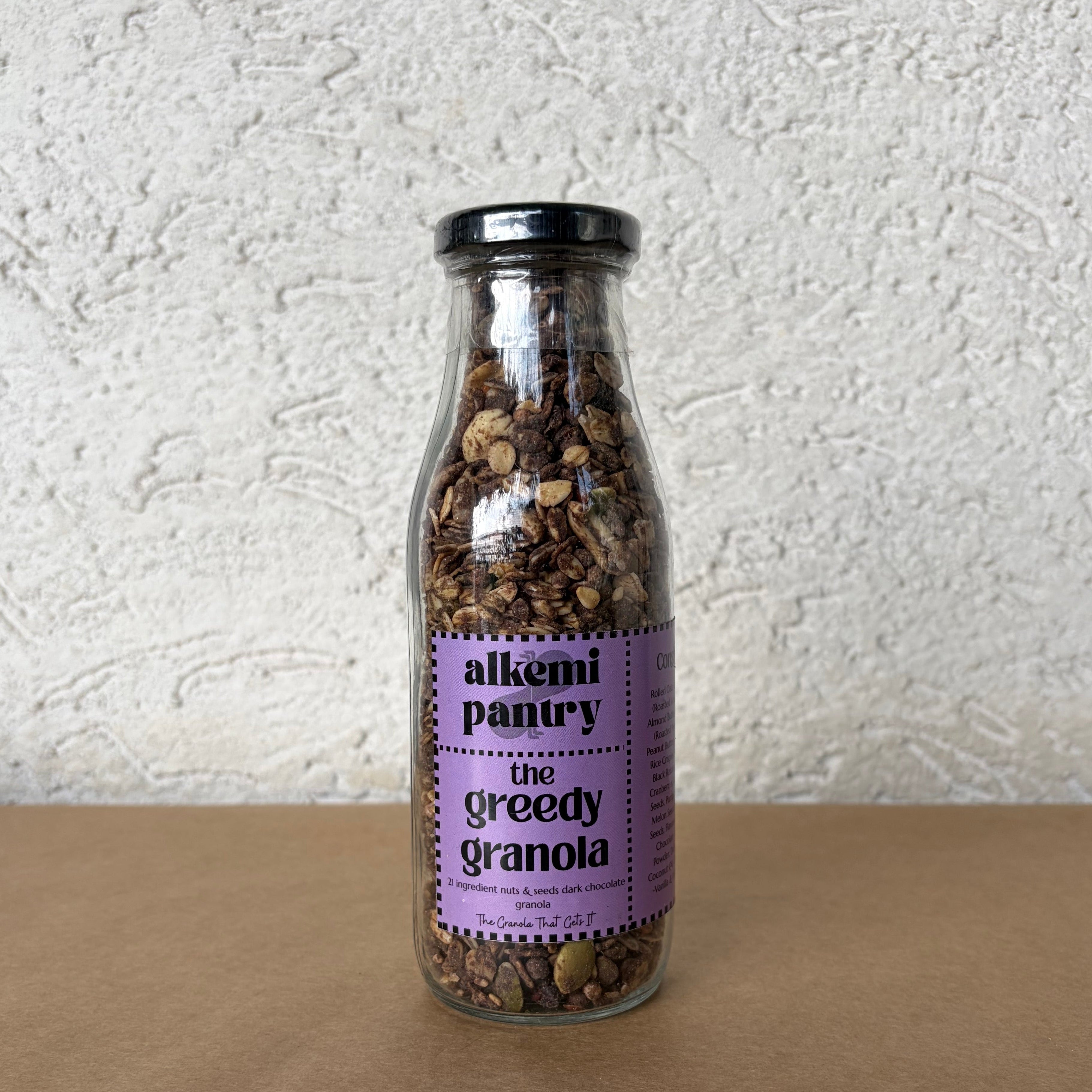 Alkemi Pantry Greedy Granola with 21 ingredients including dark chocolate, nuts and seeds for plant based breakfast, with no artificial flavoring or preservatives and double baked for perfect crunch