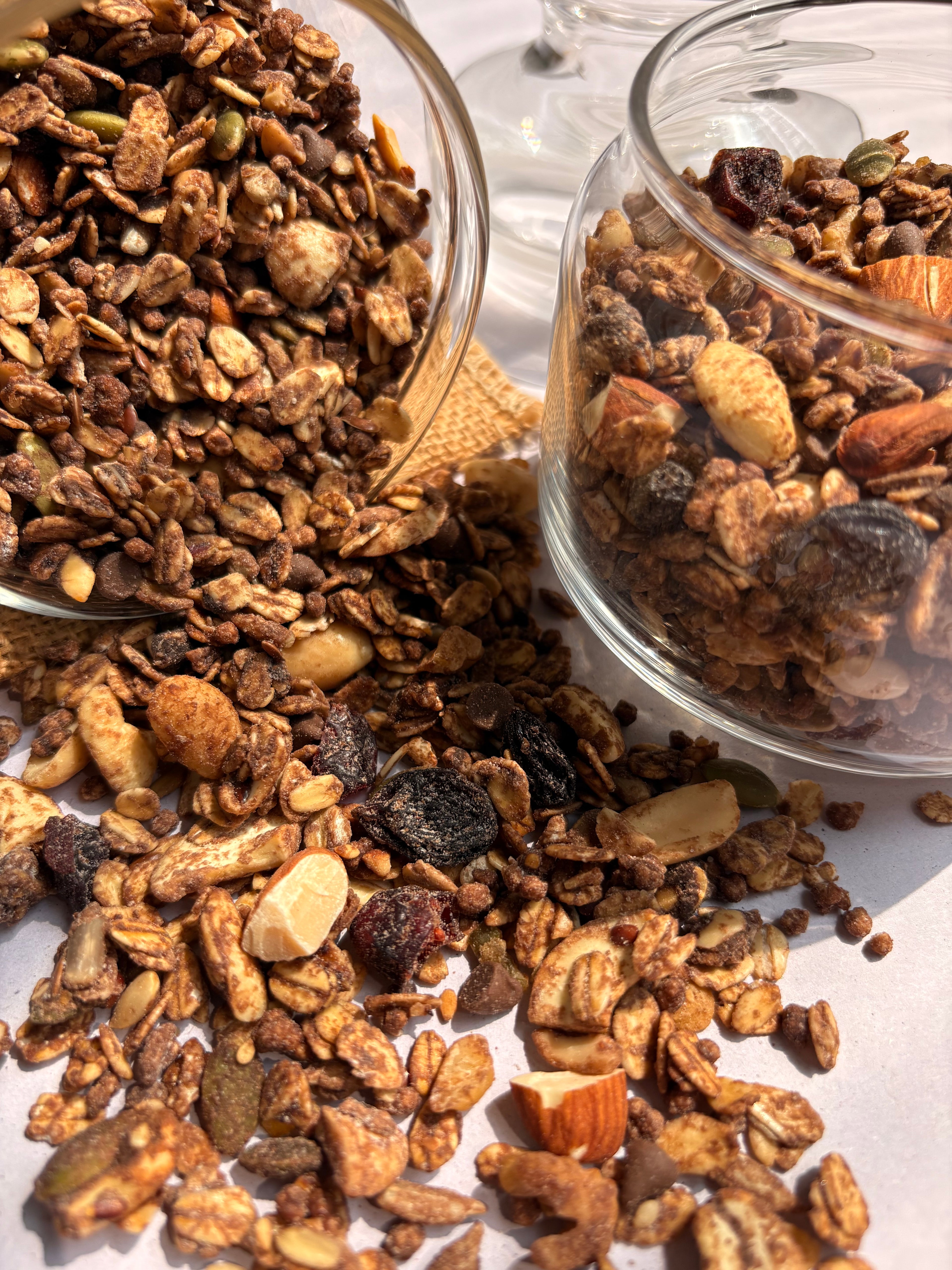 Two jars with gluten-free and plant-based granola for a healthy breakfast without additives or preservatives 