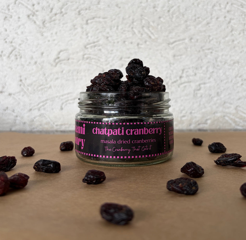 Jar of dried chatpati cranberries by Alkemi Pantry on a textured surface