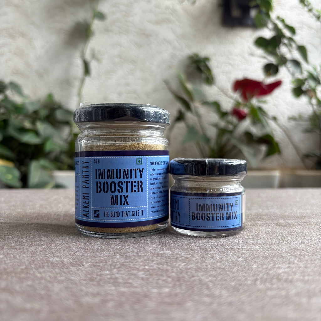 Two jars of 'Immunity Booster Mix' on a textured surface with a blurred natural background